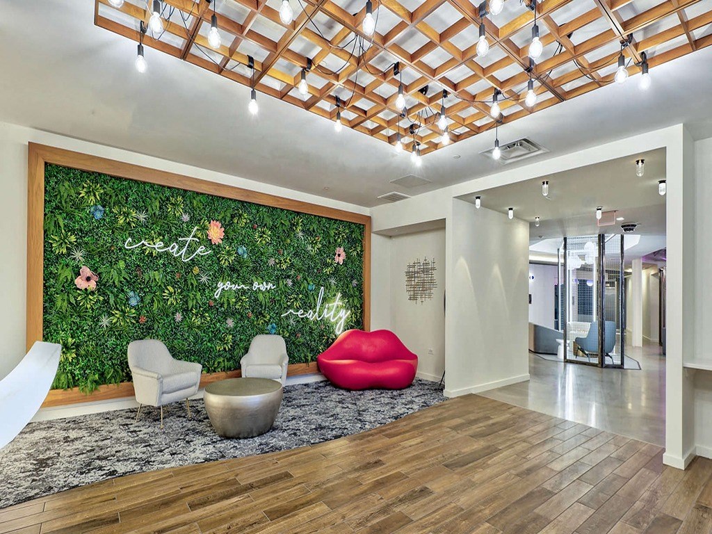 a living wall in an office with chairs and a couch